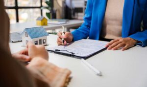 Family reviews health insurance documents and compares plan details at a kitchen table.